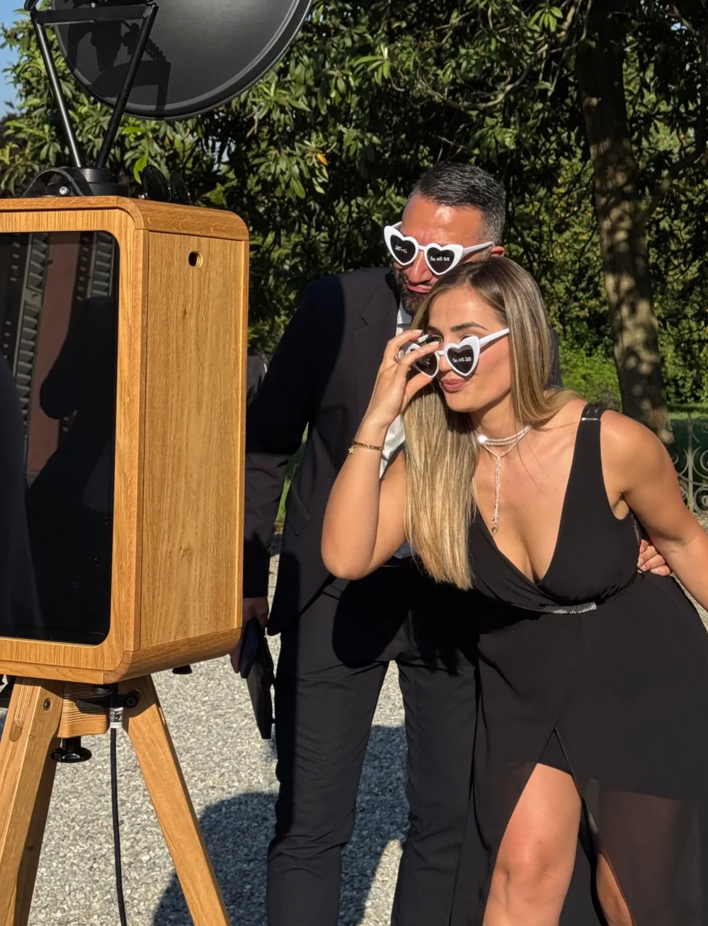 Due invitati con occhiali a cuore in posa al photo booth